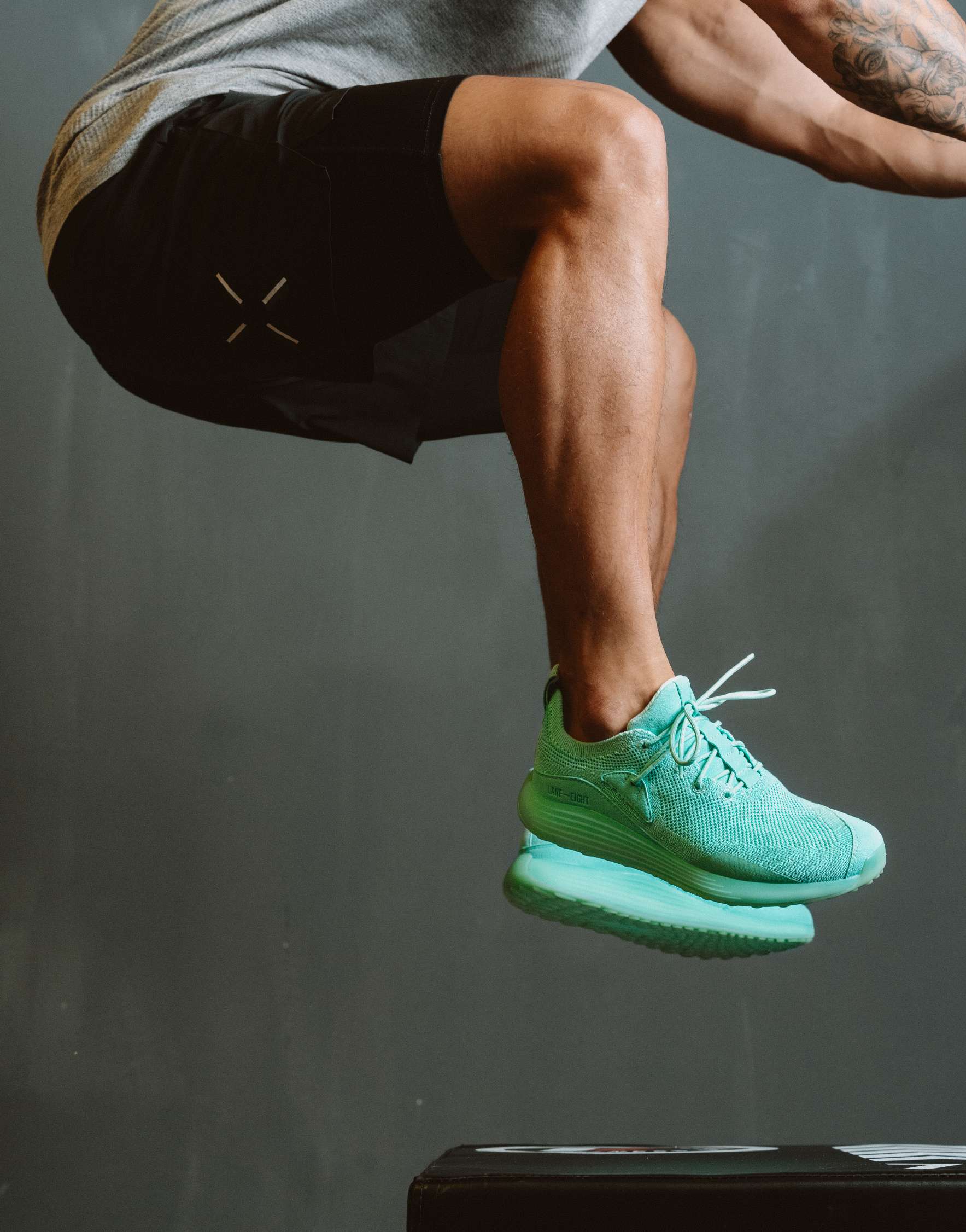 Athlete wearing 2XU compression shorts during a box jump