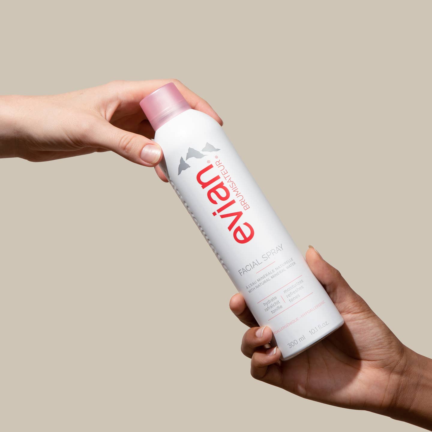 Evian Facial Spray held in two hands