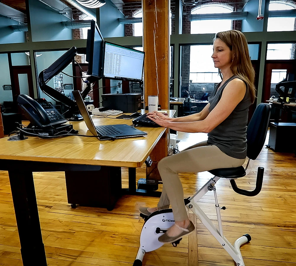 FitDesk standing desk bike in use in an office